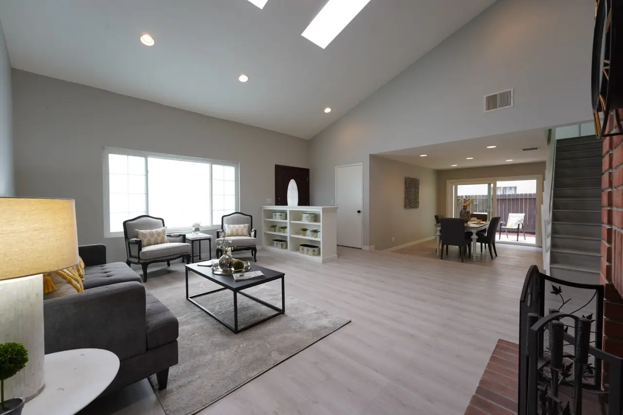 Living room with skylights, open to the dining room and the stairs