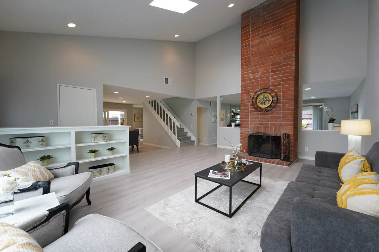 Living room with a brick fireplace and built-in shelves