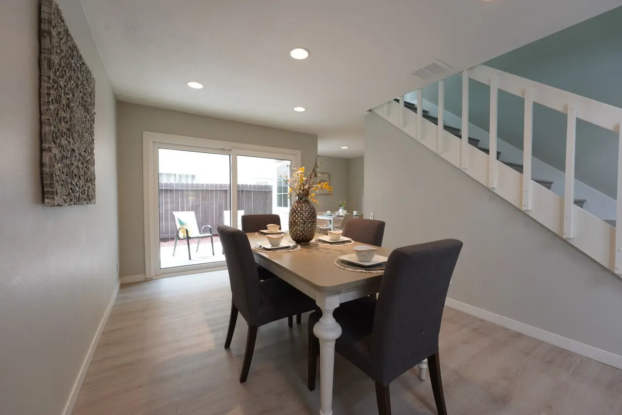 Dining room with a sliding door to the patio beside the stairs