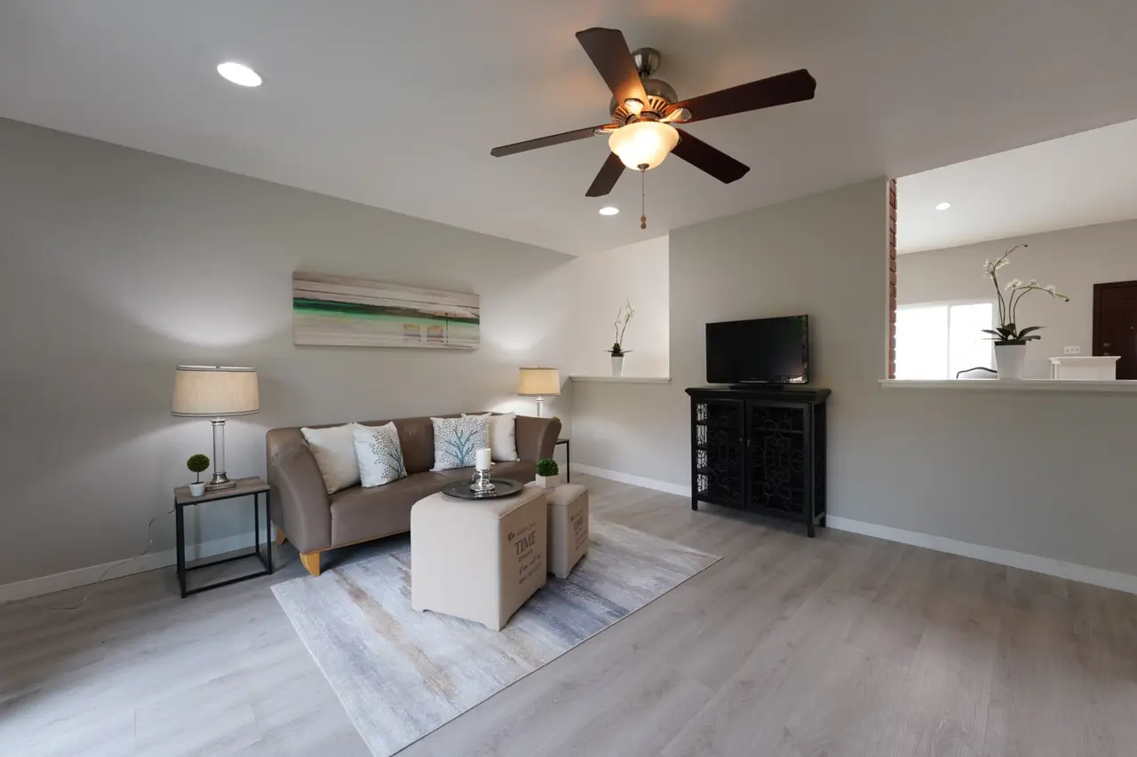 Family room with a ceiling fan and a pass-through to the kitchen