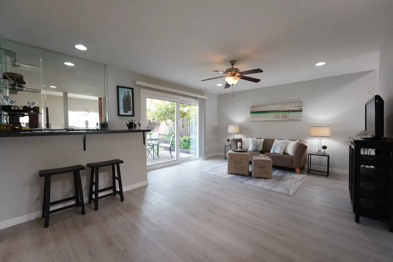 Family room with a counter and stools and a sliding door to the patio