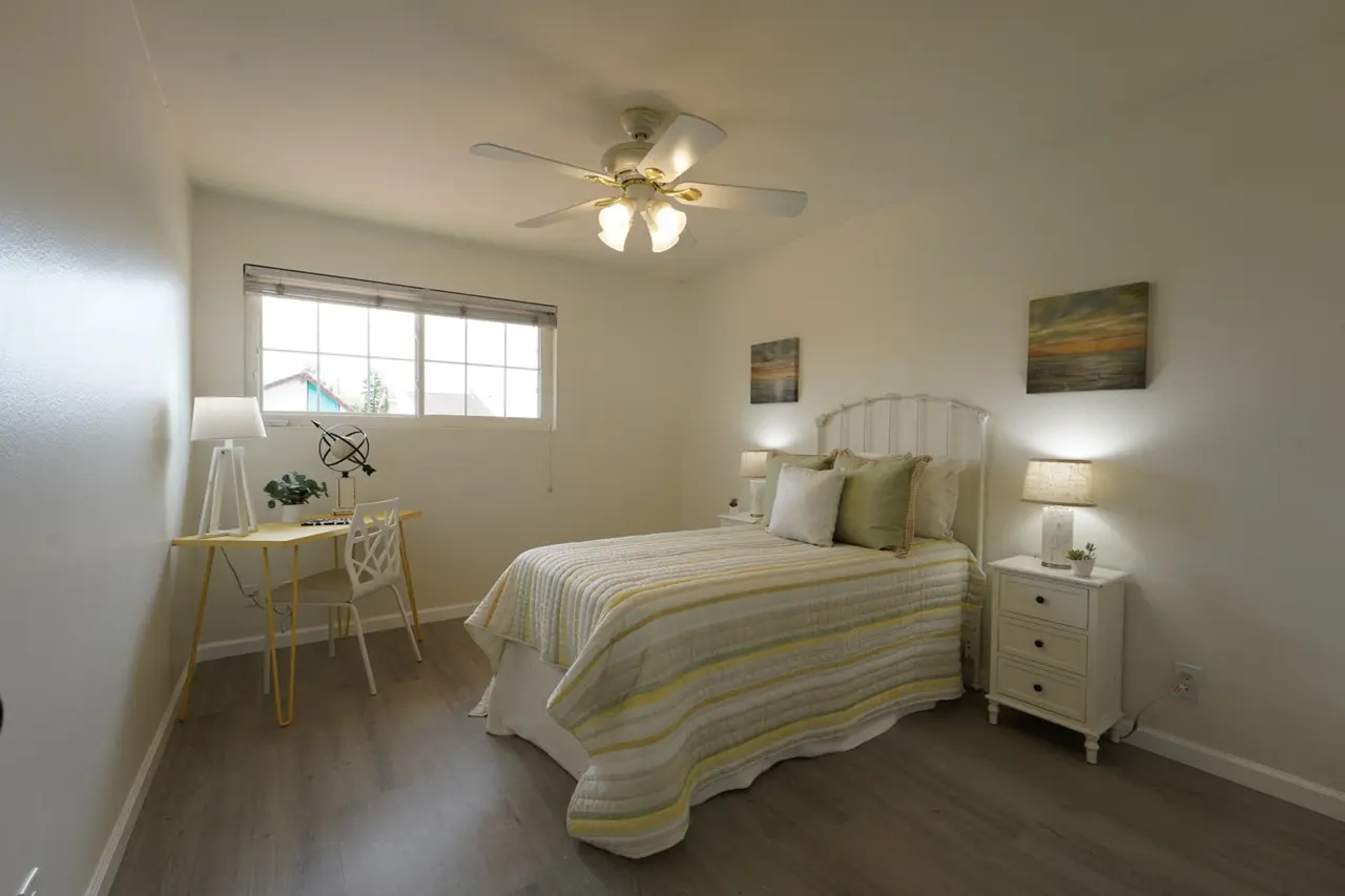 Bedroom with a ceiling fan and a window, set up with a desk