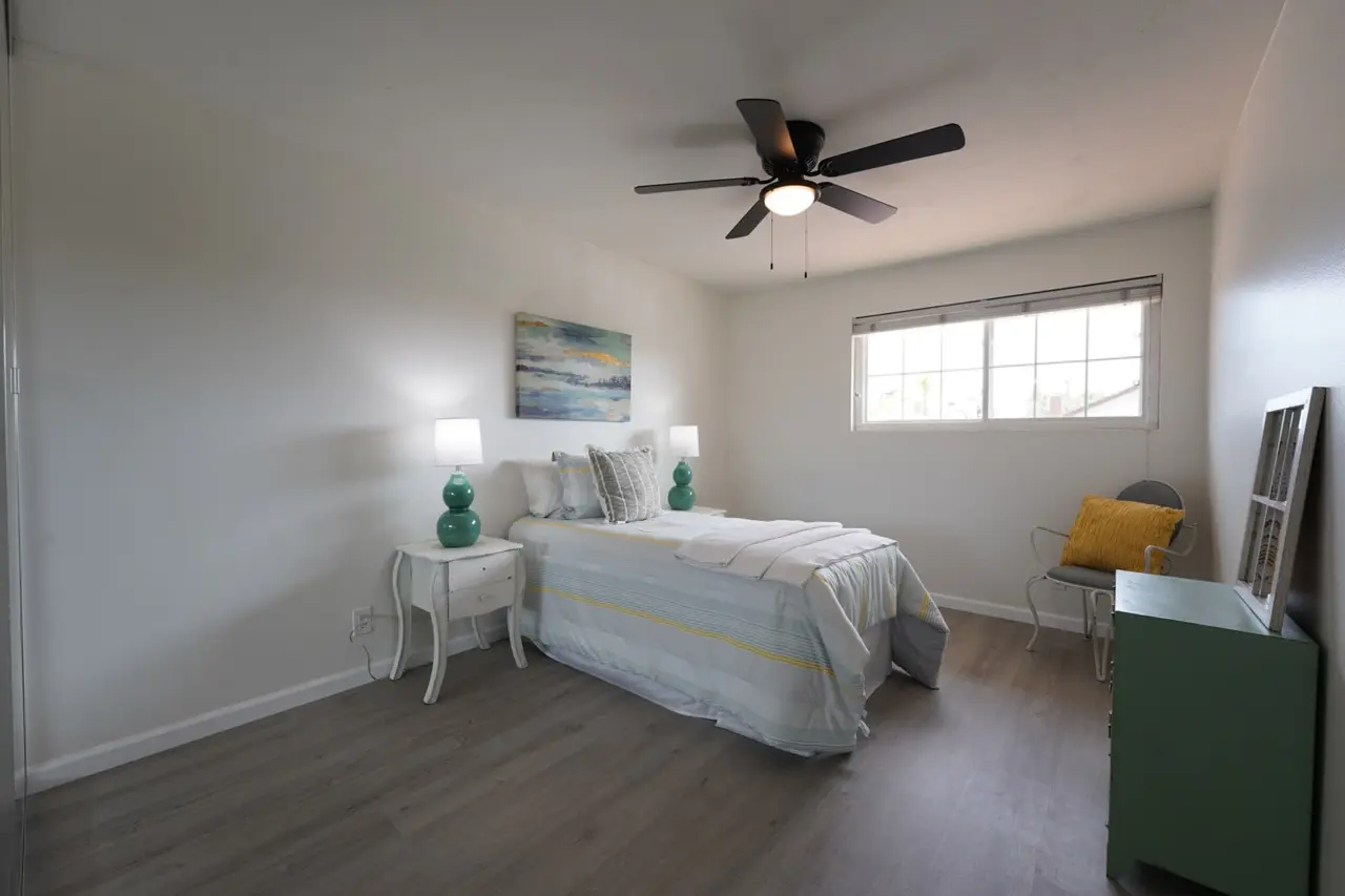 Bedroom with a ceiling fan and a window, set up with a twin bed