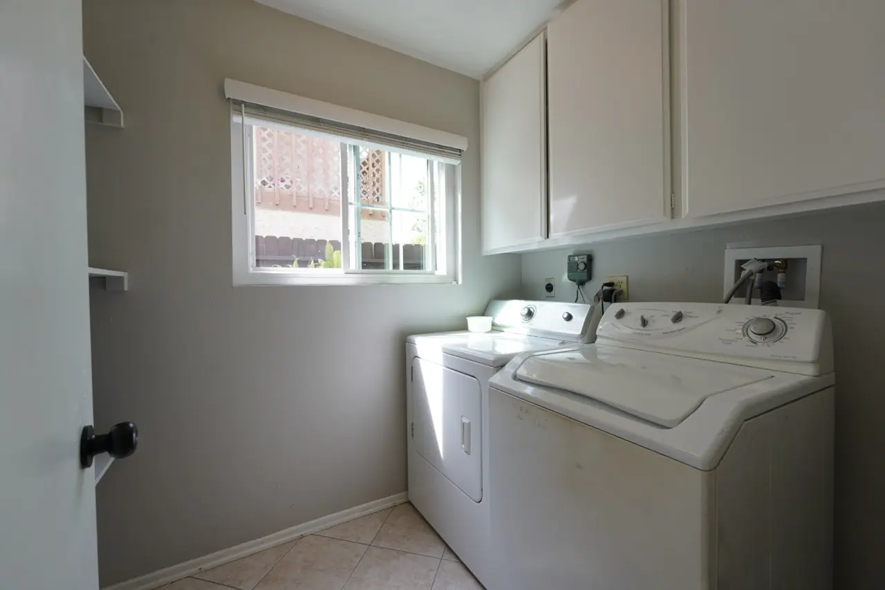 Laundry room with a washer, a dryer, and a window